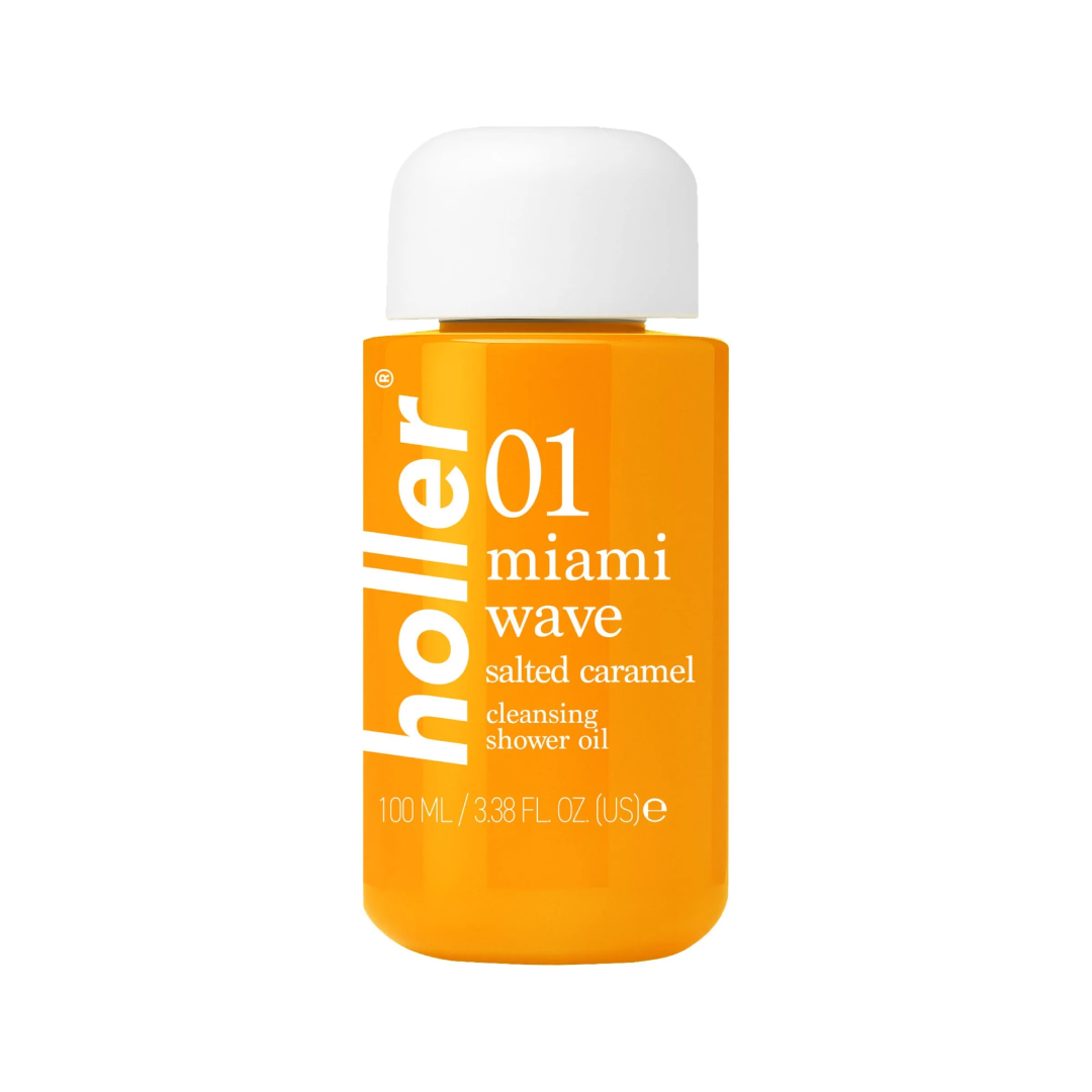 A 100 mL bottle of Holler Miami Wave Salted Caramel cleansing shower oil, featuring a vibrant orange body and a white cap, set against a plain white background.