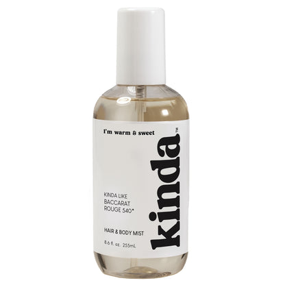 Bottle of 'kinda' hair and body mist on a white background