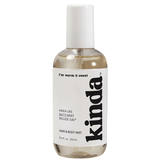 Bottle of 'kinda' hair and body mist on a white background